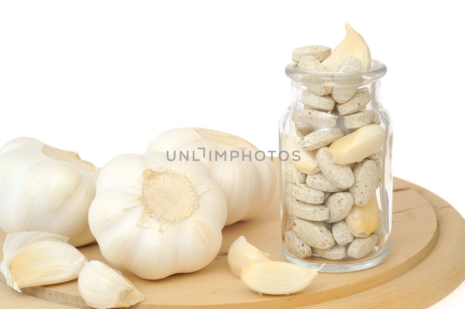 Garlic and herbal supplement pills isolated, alternative medicine concept