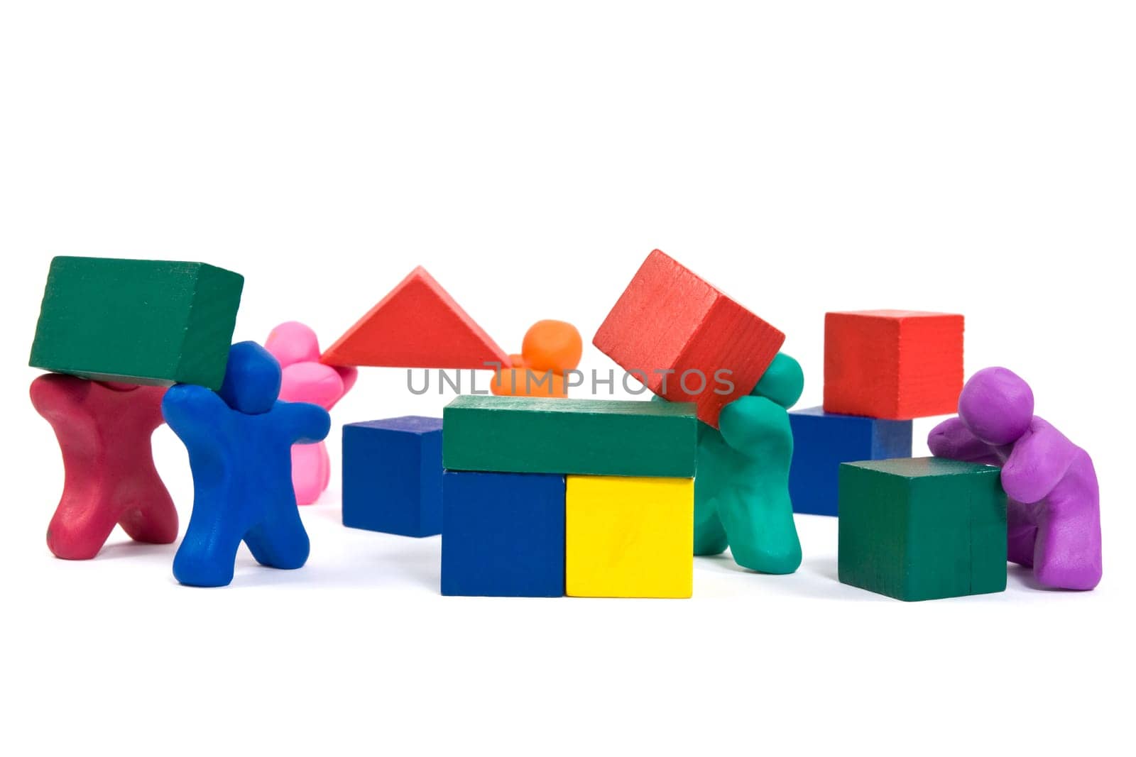 plasticine people working as a team, building wooden blocks