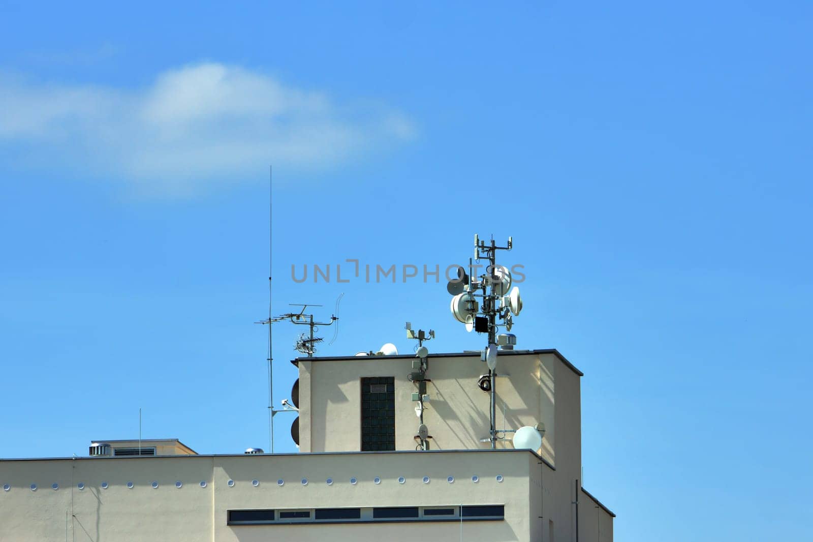 satellite communications dishes on roof panel building