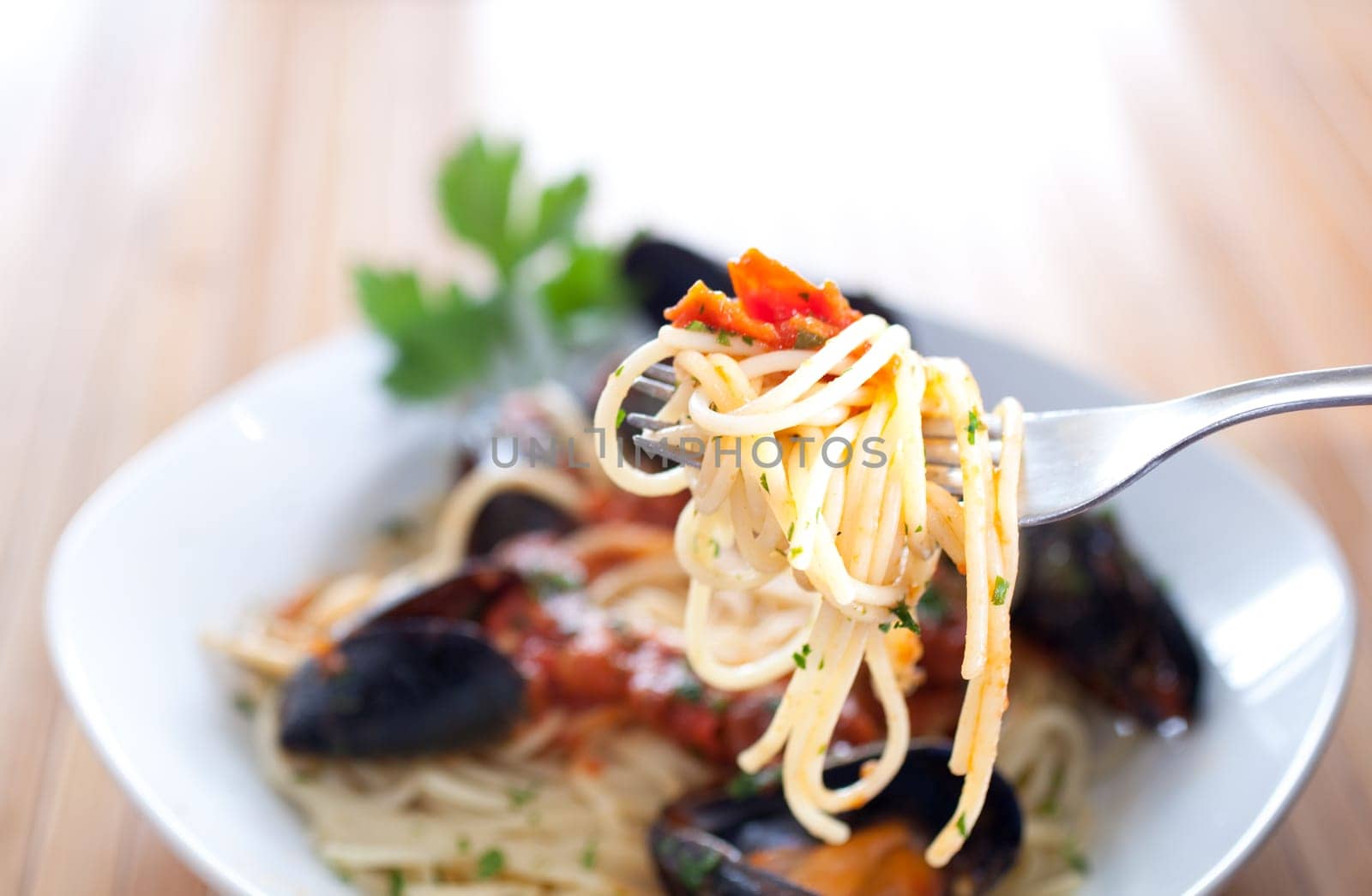 Spaghetti with mussels on wooden table