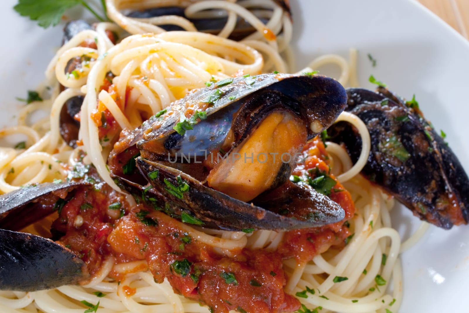 Spaghetti with mussels on wooden table
