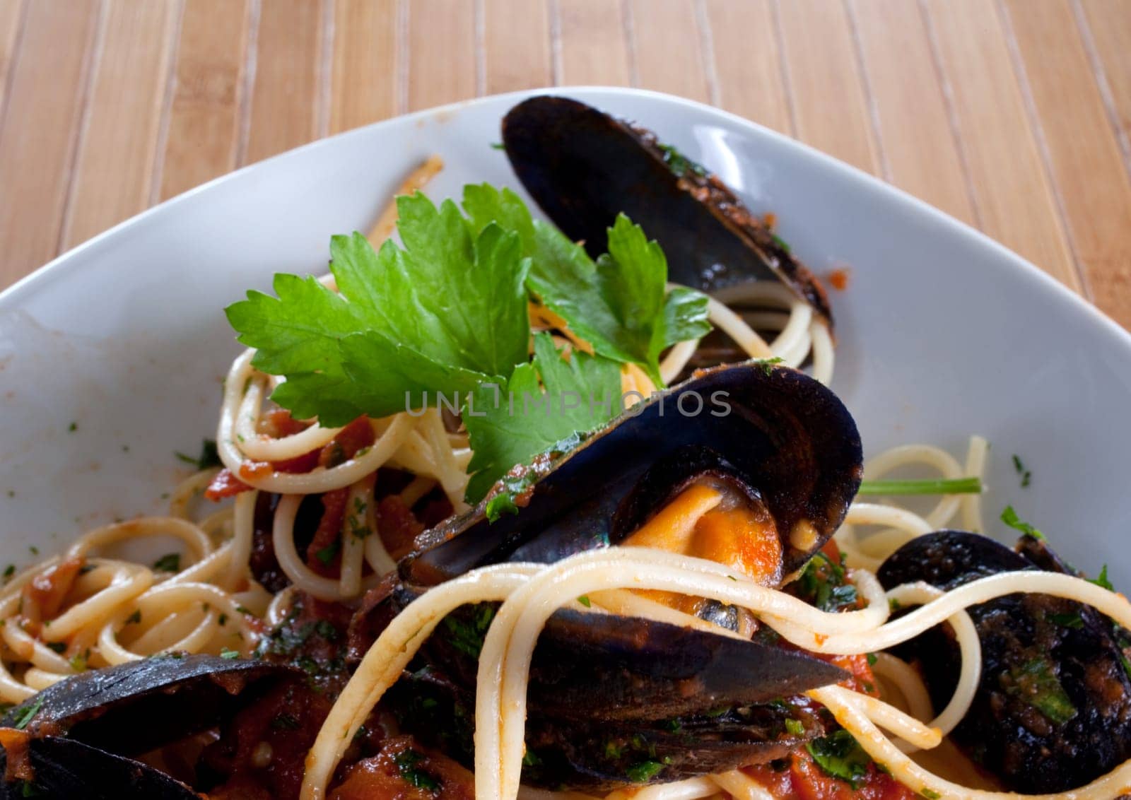 Spaghetti with mussels on wooden table