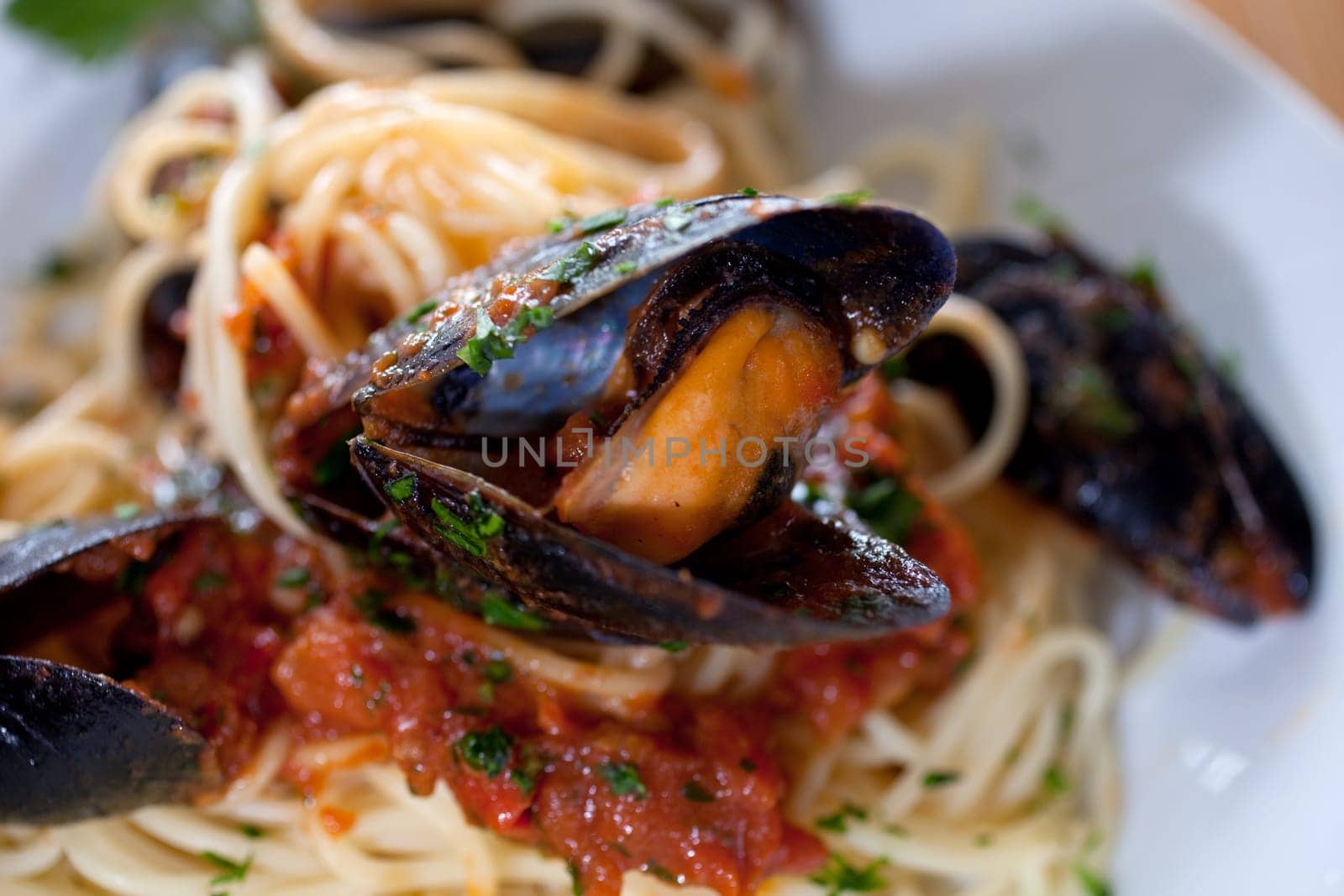 Spaghetti with mussels on wooden table