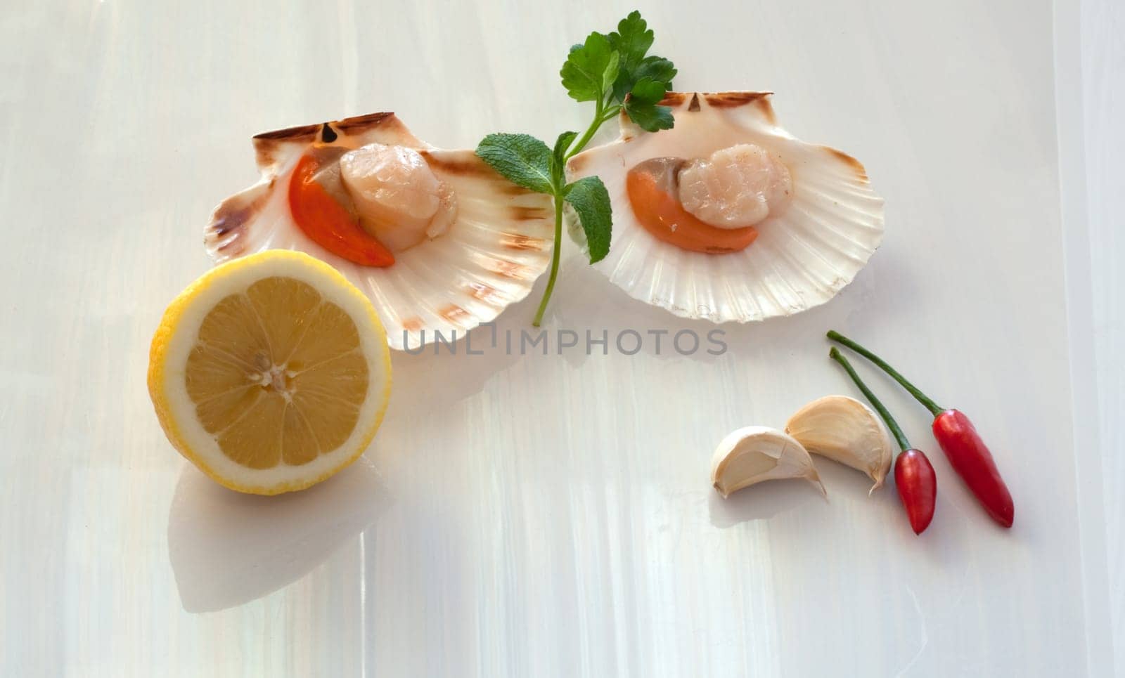 Cappesante and lemon on a white background