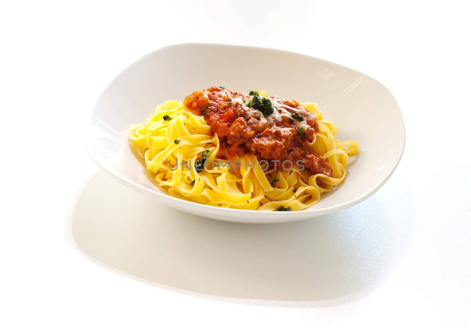 Italian pasta with ragout sauce on white background