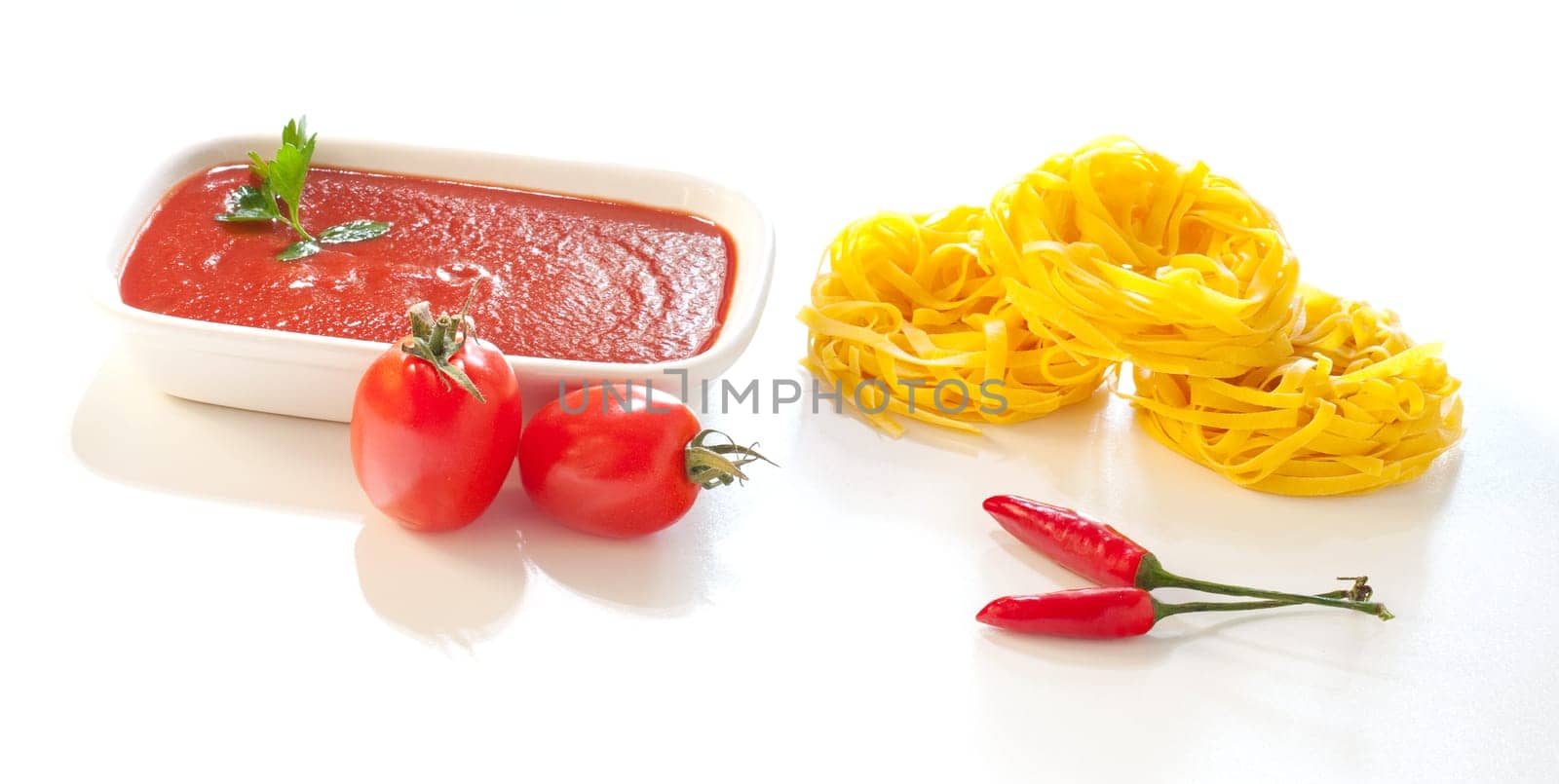 Tomatoes, tagliatelle, chili peppers and tomatoes sauce, Ingredients for italian pasta on white background
