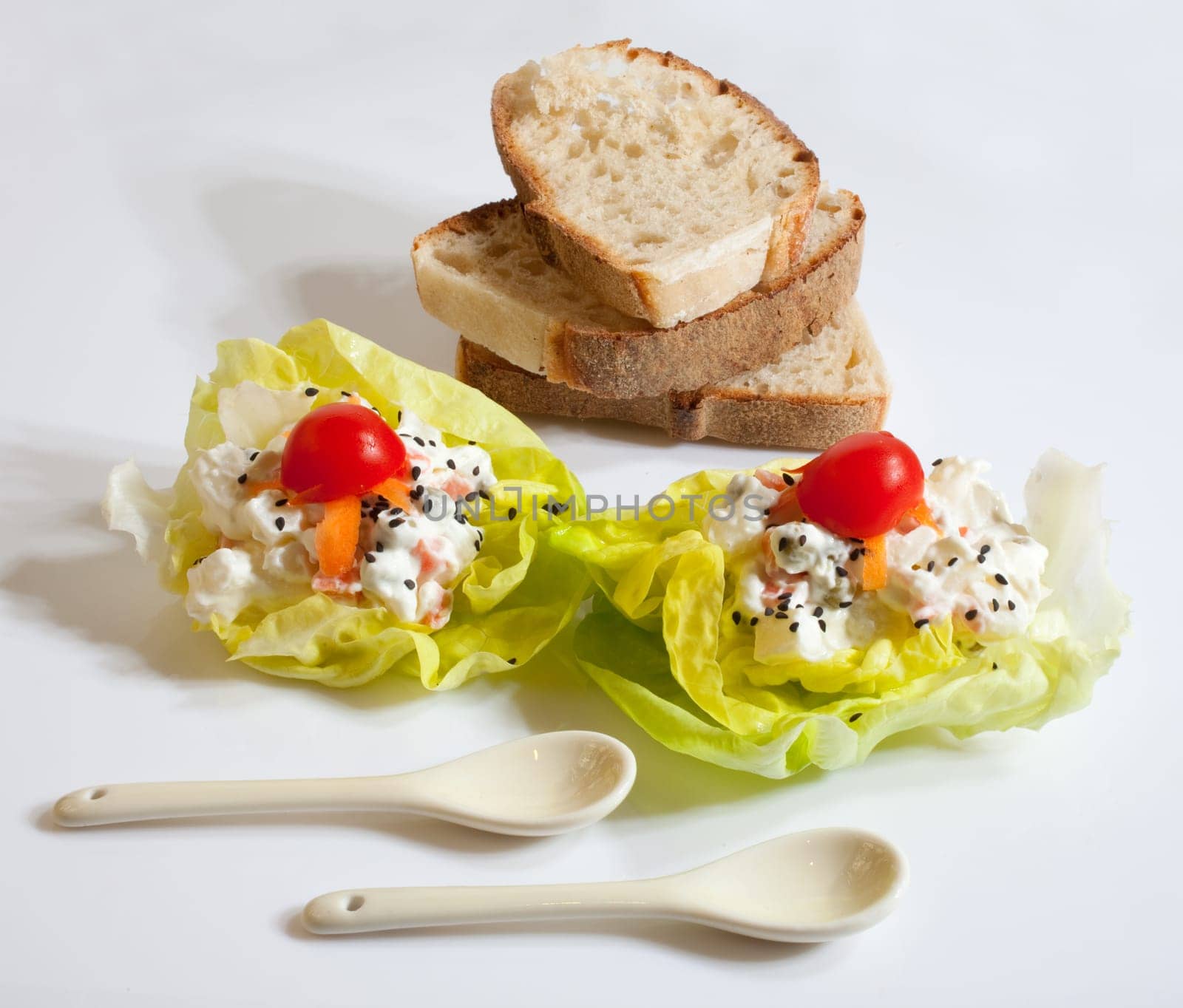 Bread and fresh salad on white