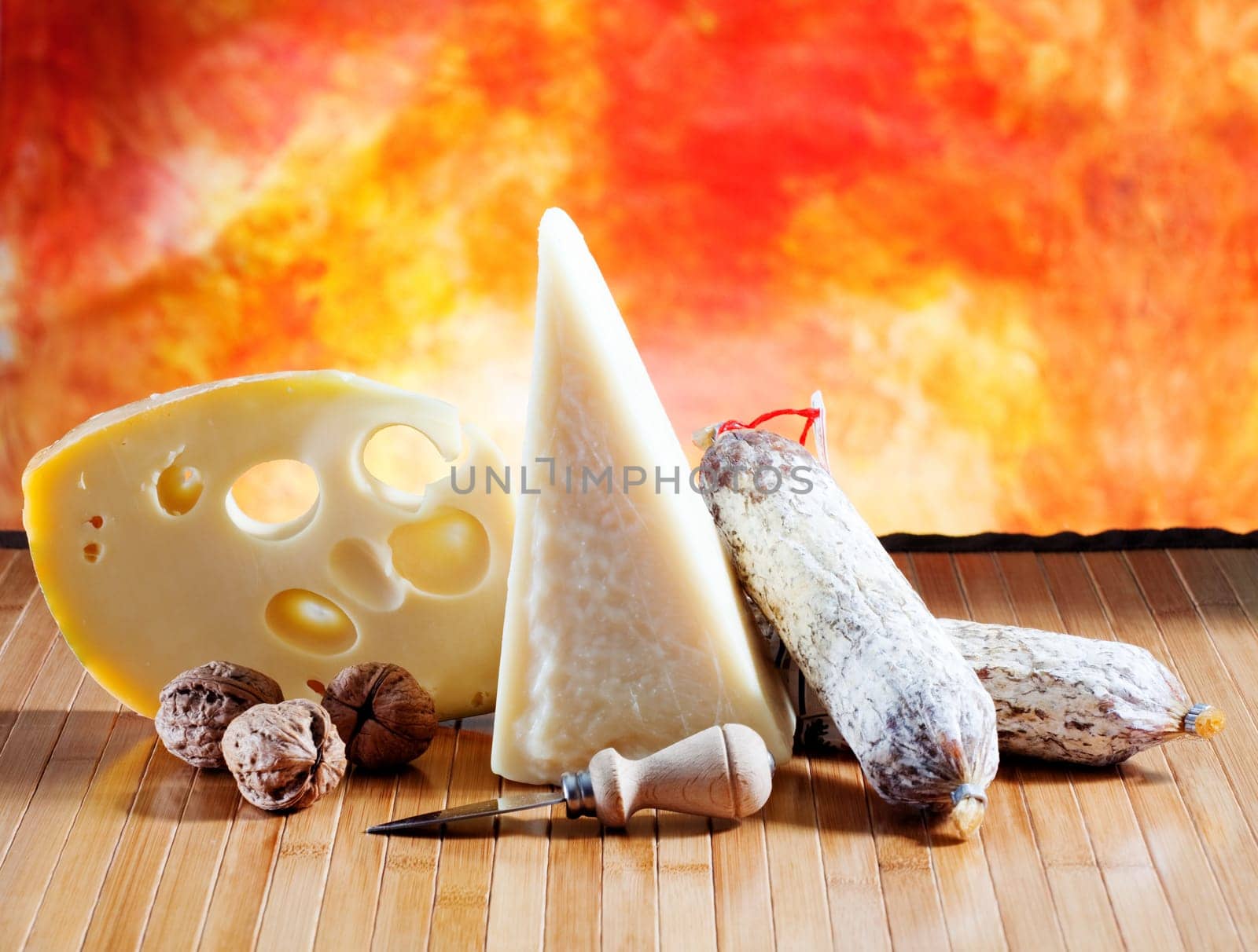 Italian cheese and salumi on a orange background