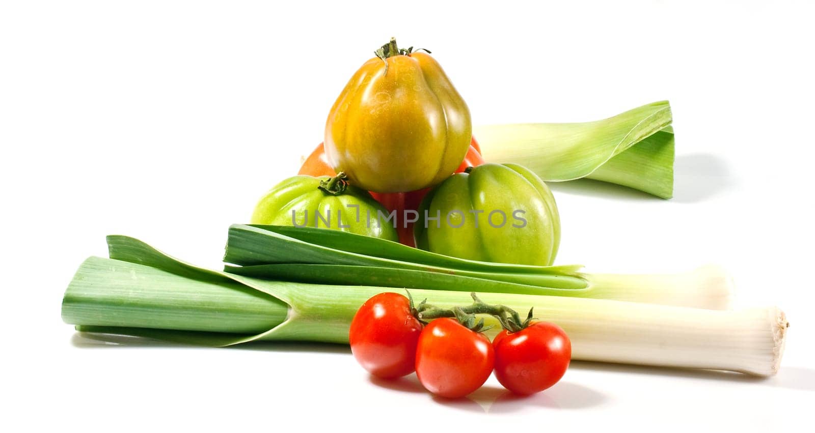 Leeks and tomatoes isolated on a white background