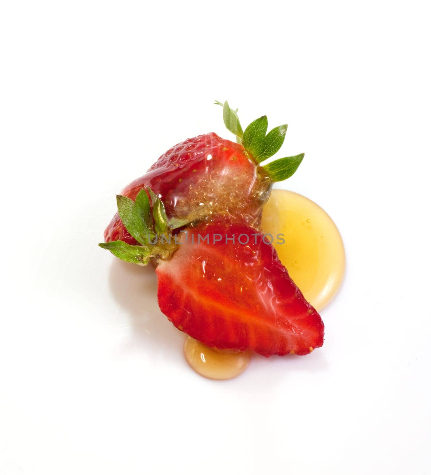Strawberries and honey on white