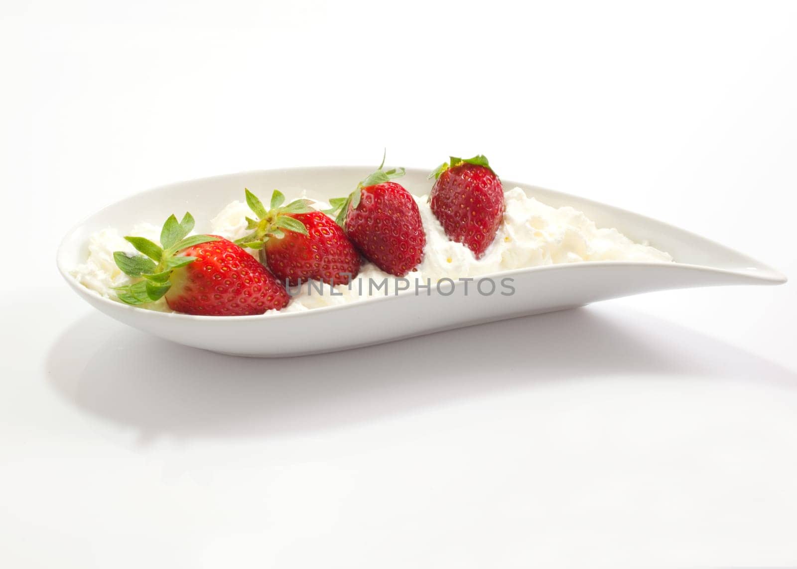 Strawberries and cream on saucer
