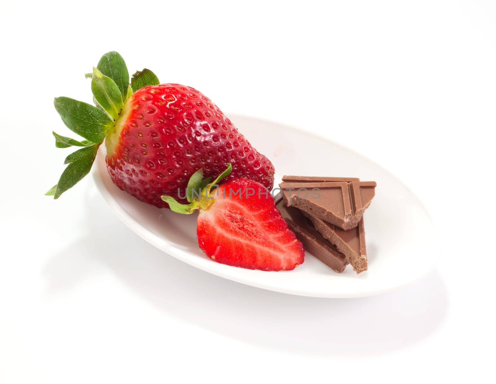 Strawberries and chocolate on saucer