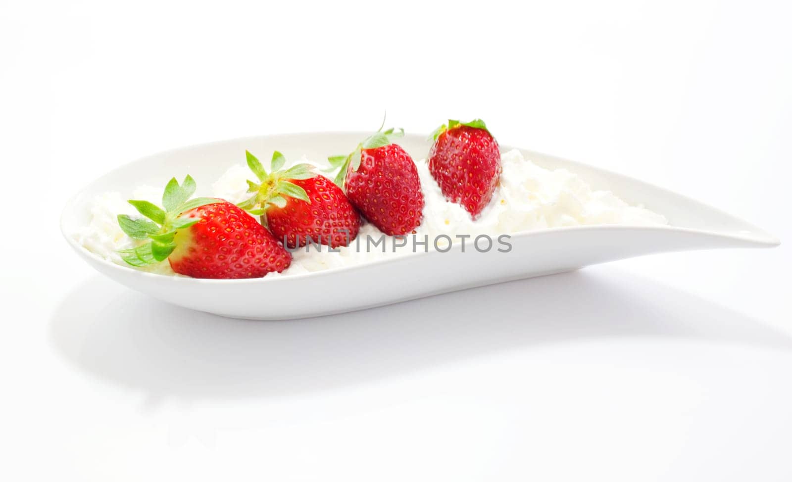 Strawberries and cream on saucer