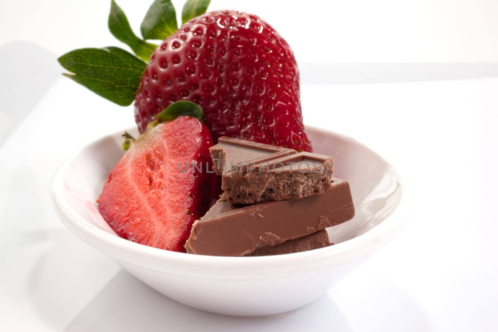 Strawberries and chocolate on saucer