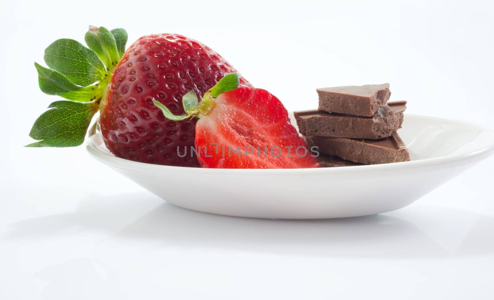 Strawberries and chocolate on saucer