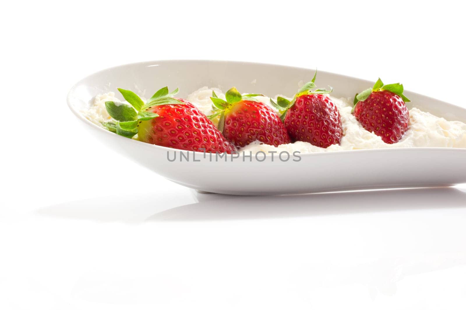 Strawberries and cream on saucer