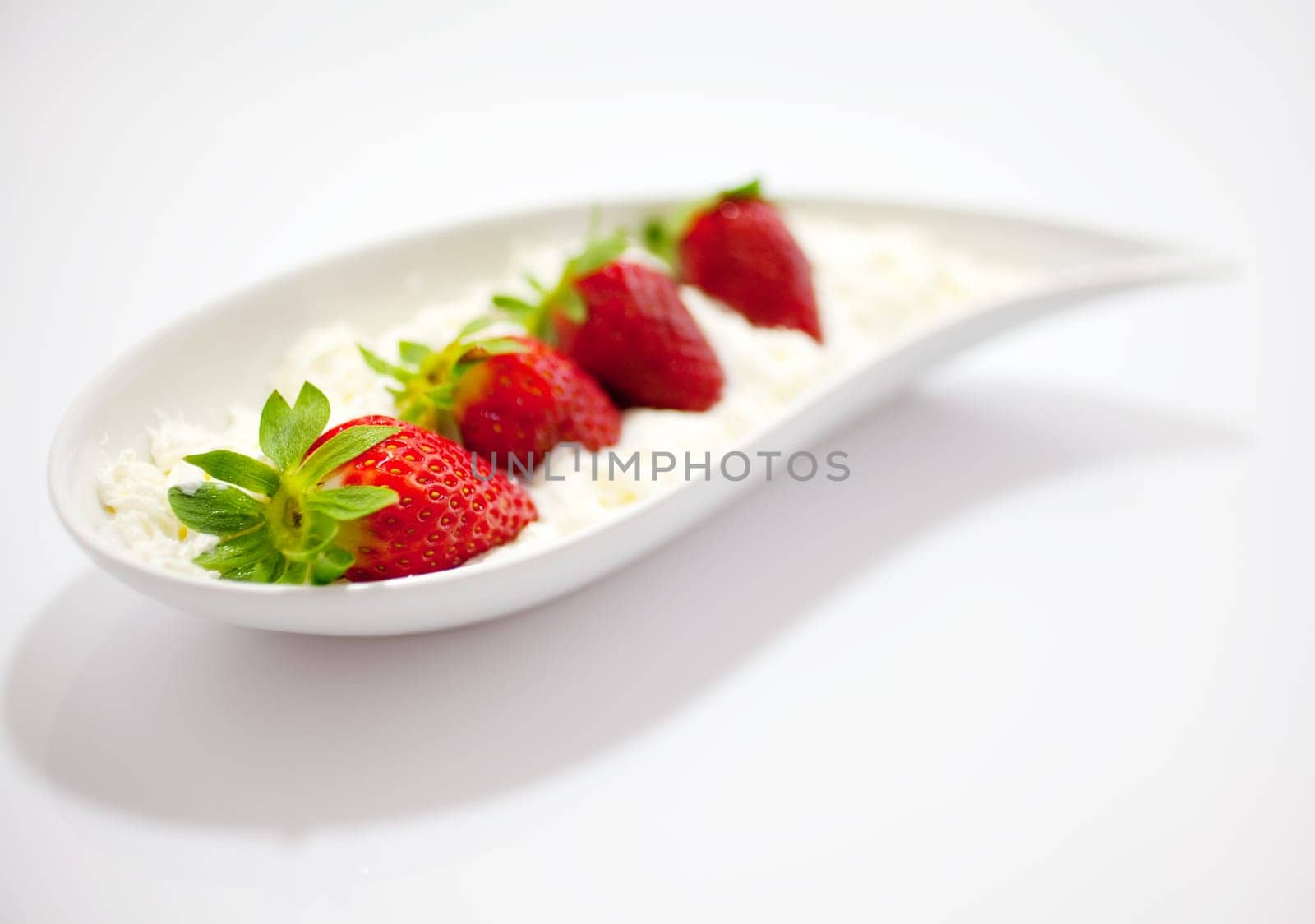 Strawberries and cream on saucer