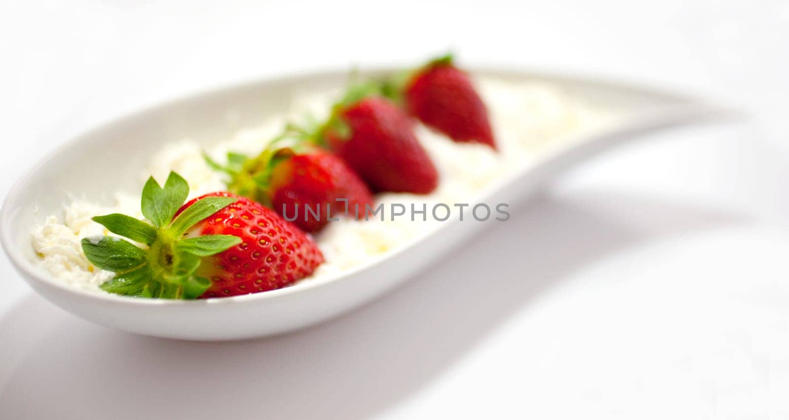 Strawberries and cream on saucer