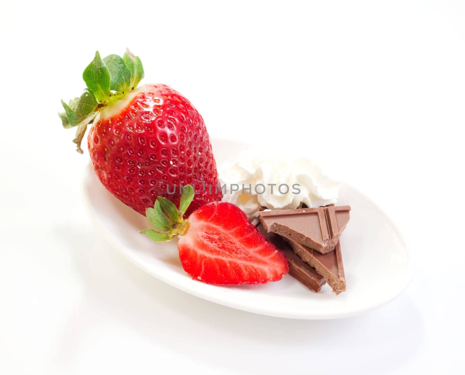 Strawberries cream and chocolate on saucer