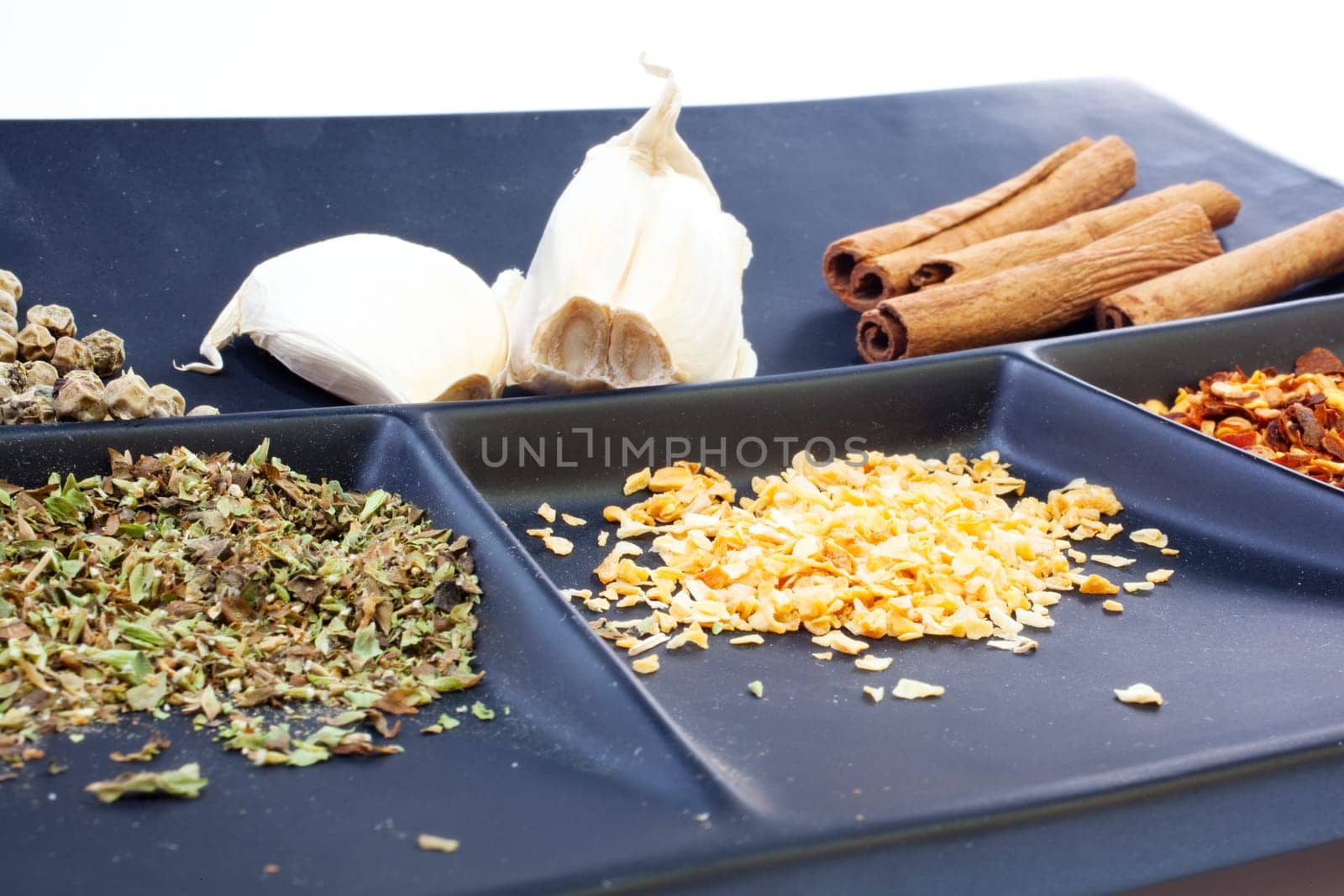 Different Spices on a black saucer