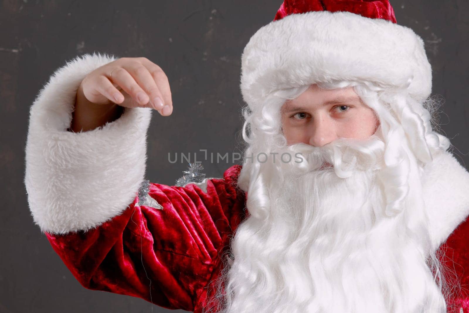 Santa Claus showing onto a red mitten