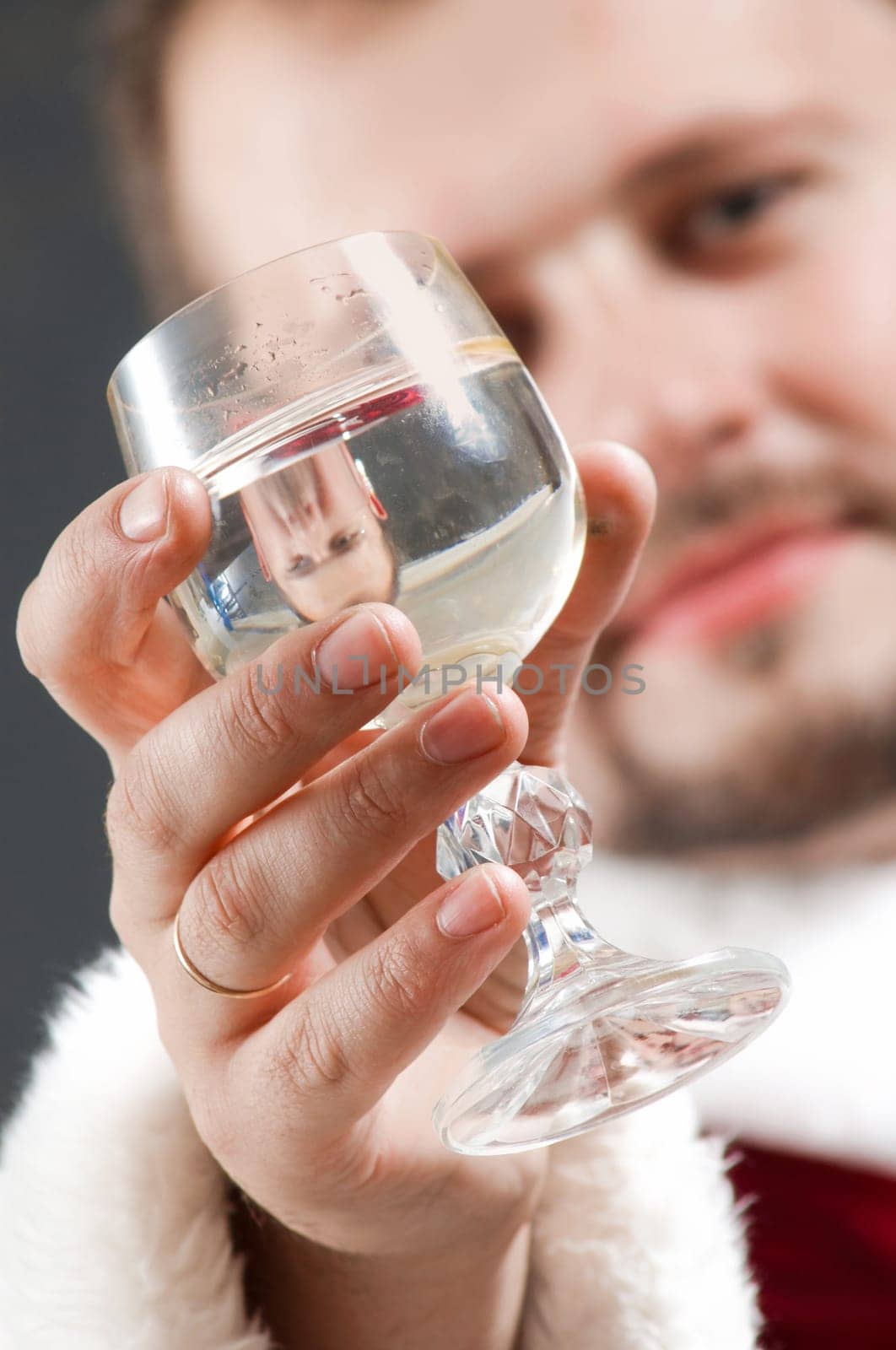 Santa Claus is preparing to celebrate Christmas. Drinking wine