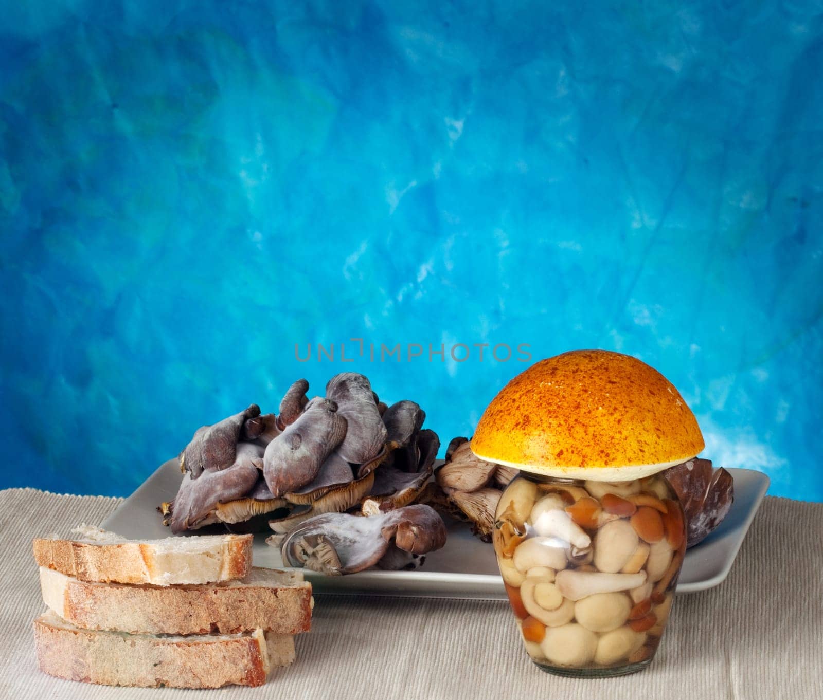 Mushrooms inside a jar on a blue background