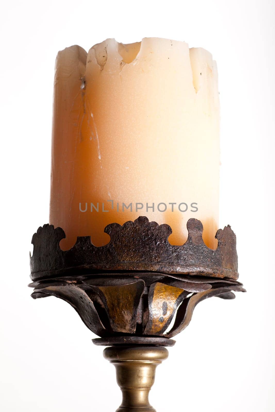 Ancient big candle on white