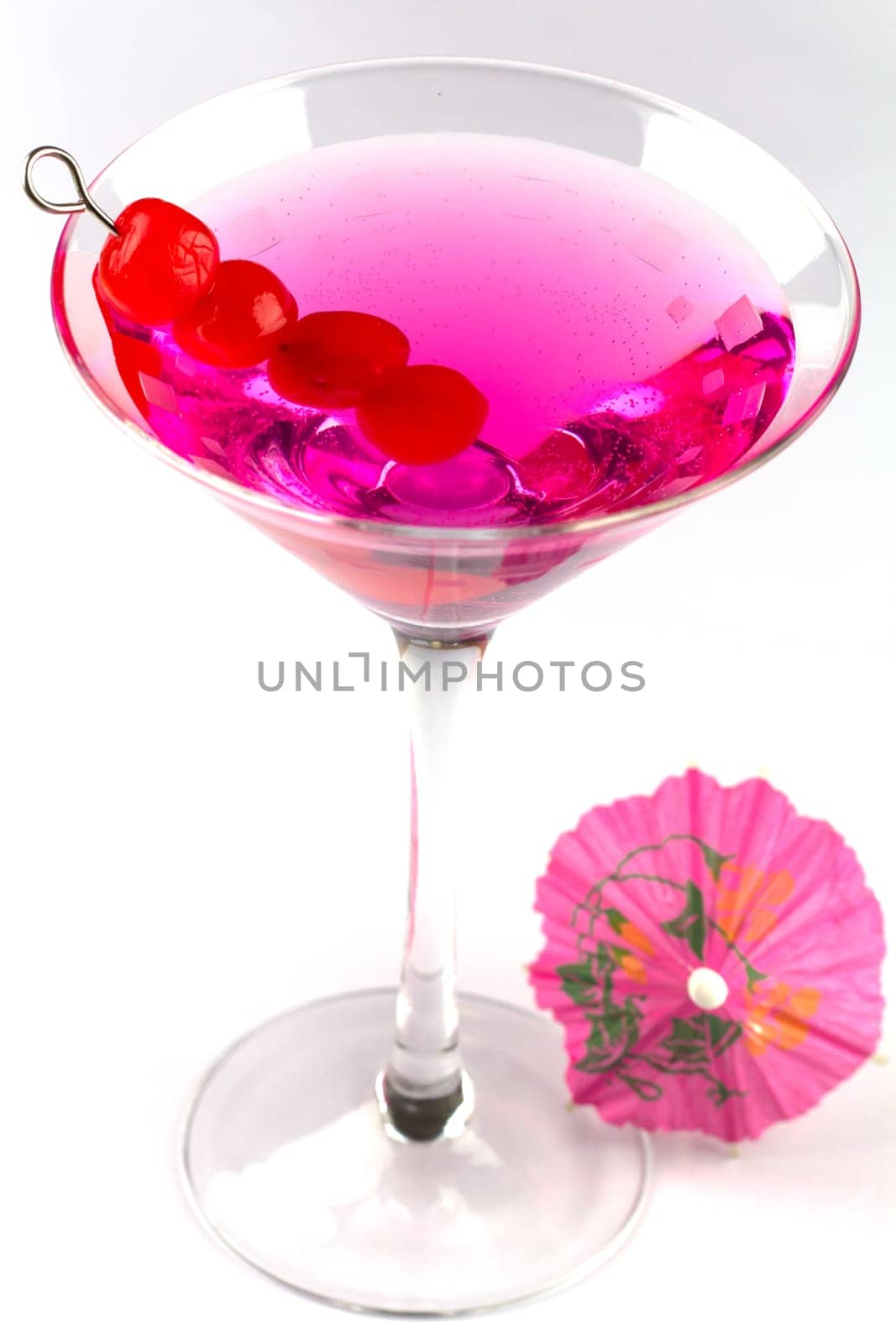 A refreshing cocktail with cherry and decorated with an umbrella