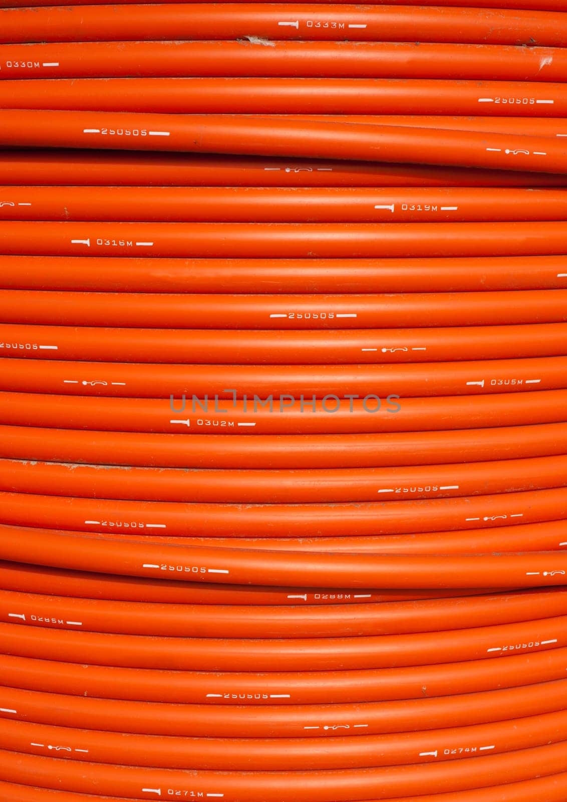 orange telephone cable on a cable drum