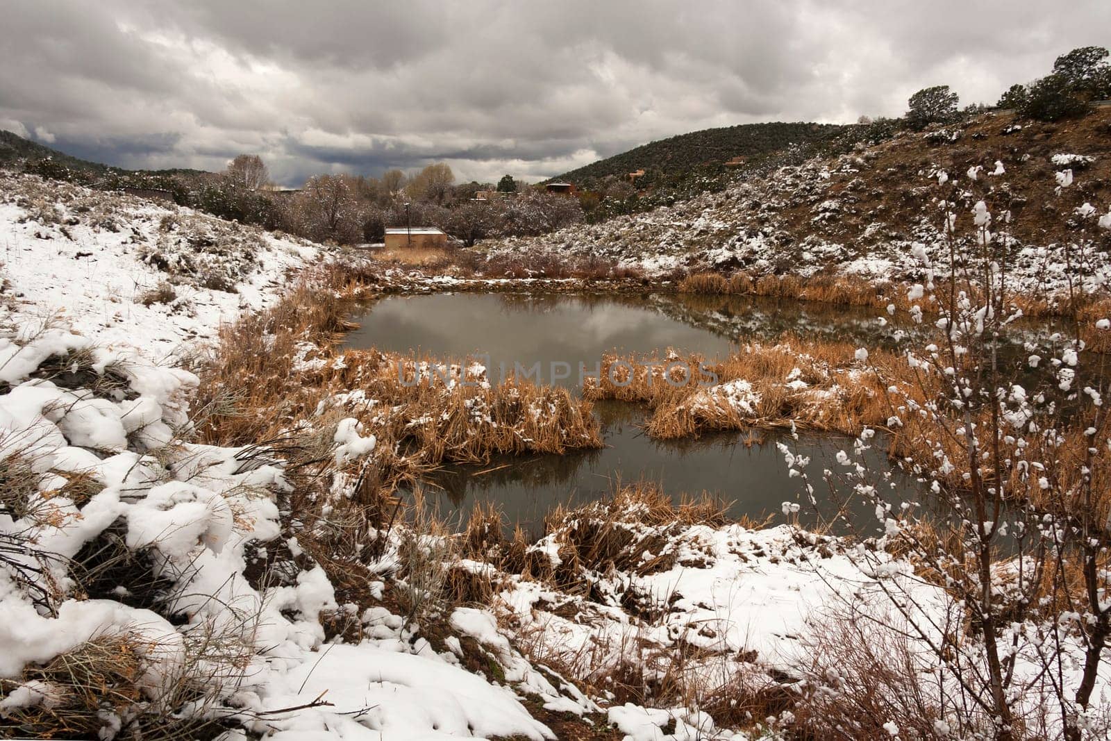 Landscape in the desert with snow and a reservoir
