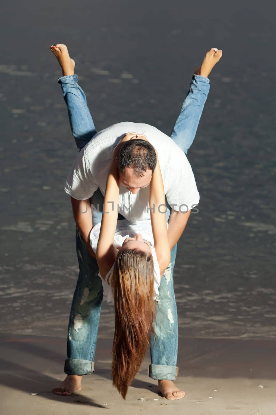 Young couple near the sea at sunrise