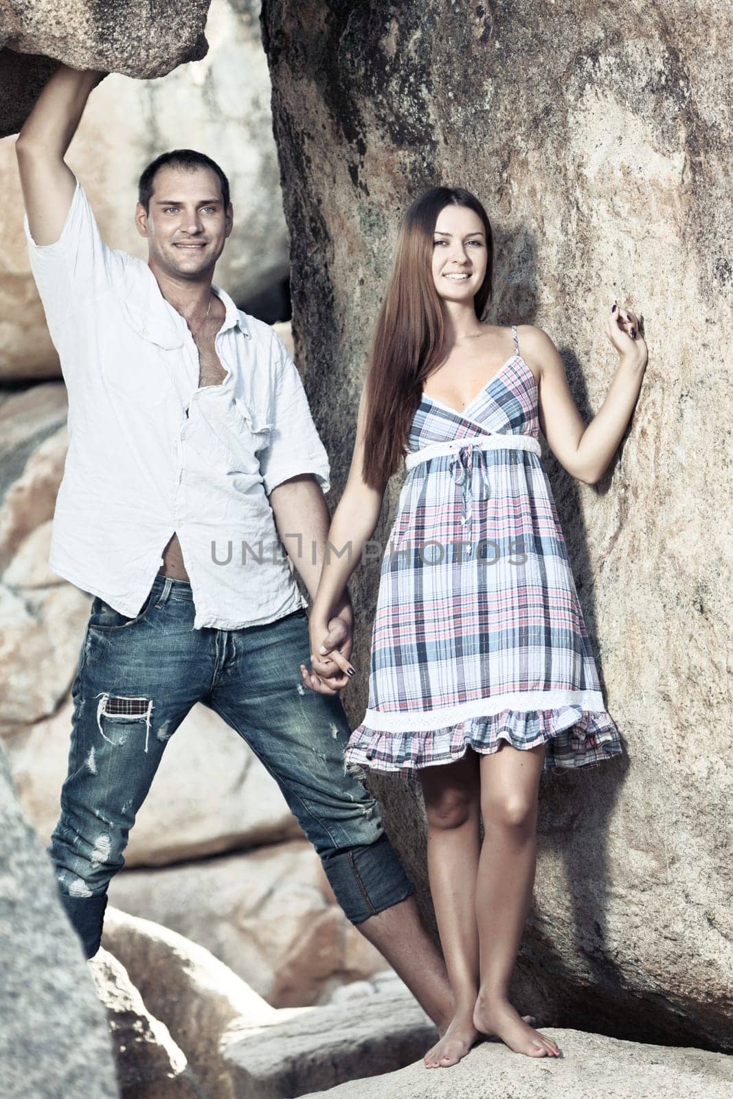 portrait of attractive young couple on the cliff.