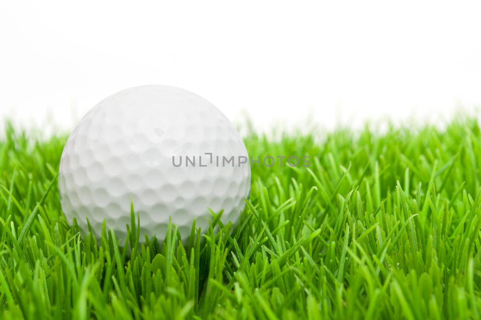 Golf Ball in Grass Isolated on White