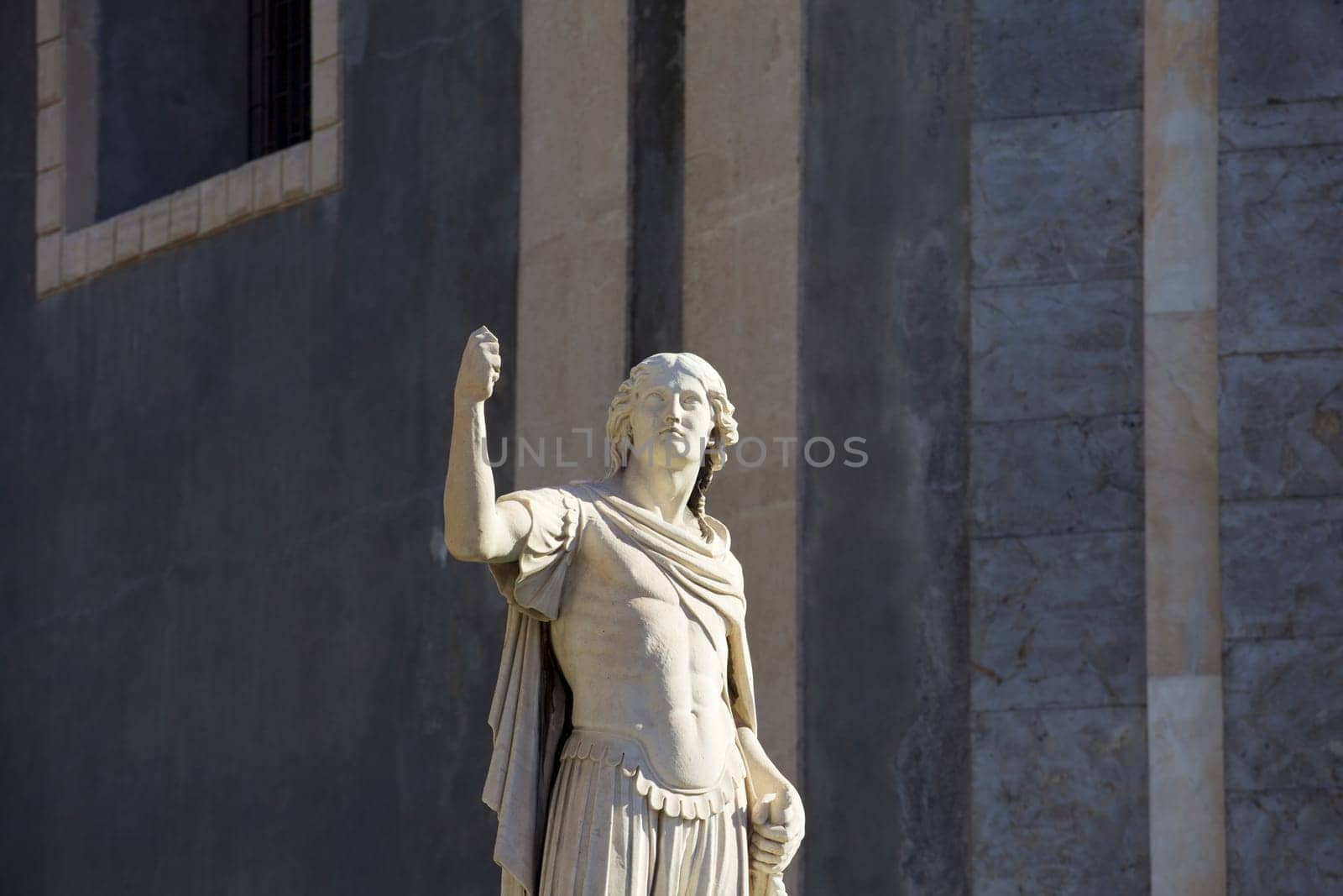 Statue of an ancient religious figure next to the cathedral of Catania