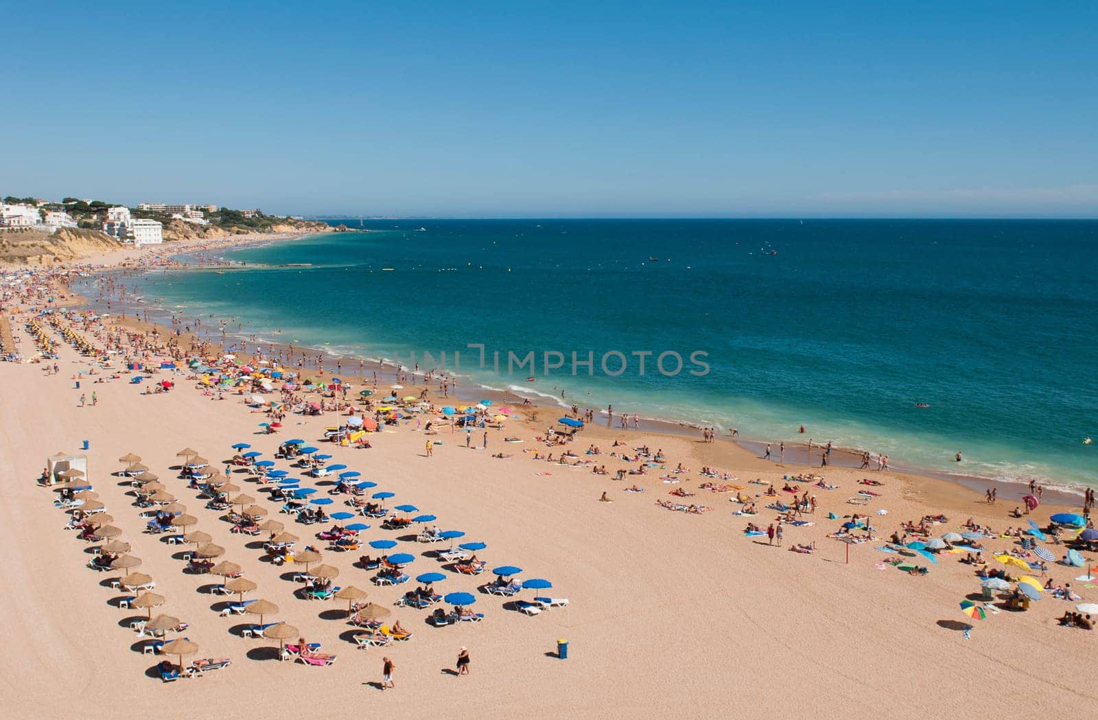 ALBUFEIRA, PORTUGAL - AUGUST 30: tourists and locals enjoying a sunny day at the beach in Algarve on August 30, 2011 in Albufeira, Portugal. It is the most touristic place in the region during all year.