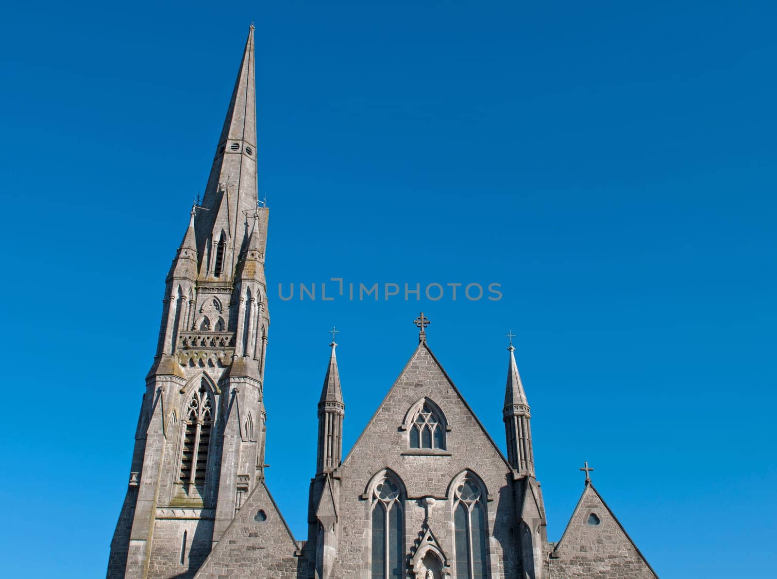 up view of Saint John&#039 s cathedral in Limerick, Ireland (blue sky background)