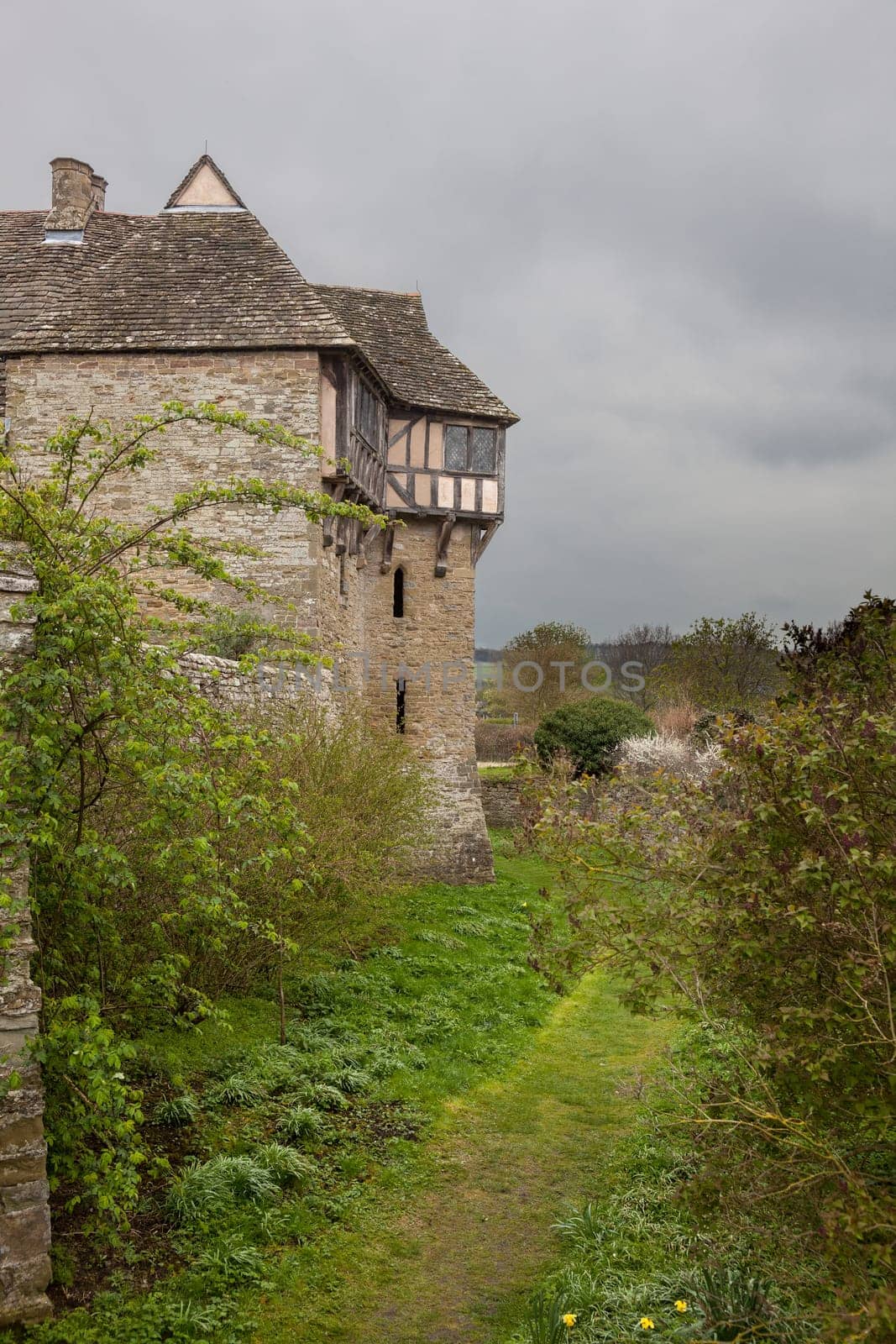Moat around Stokesay castle on a dark cloudy day