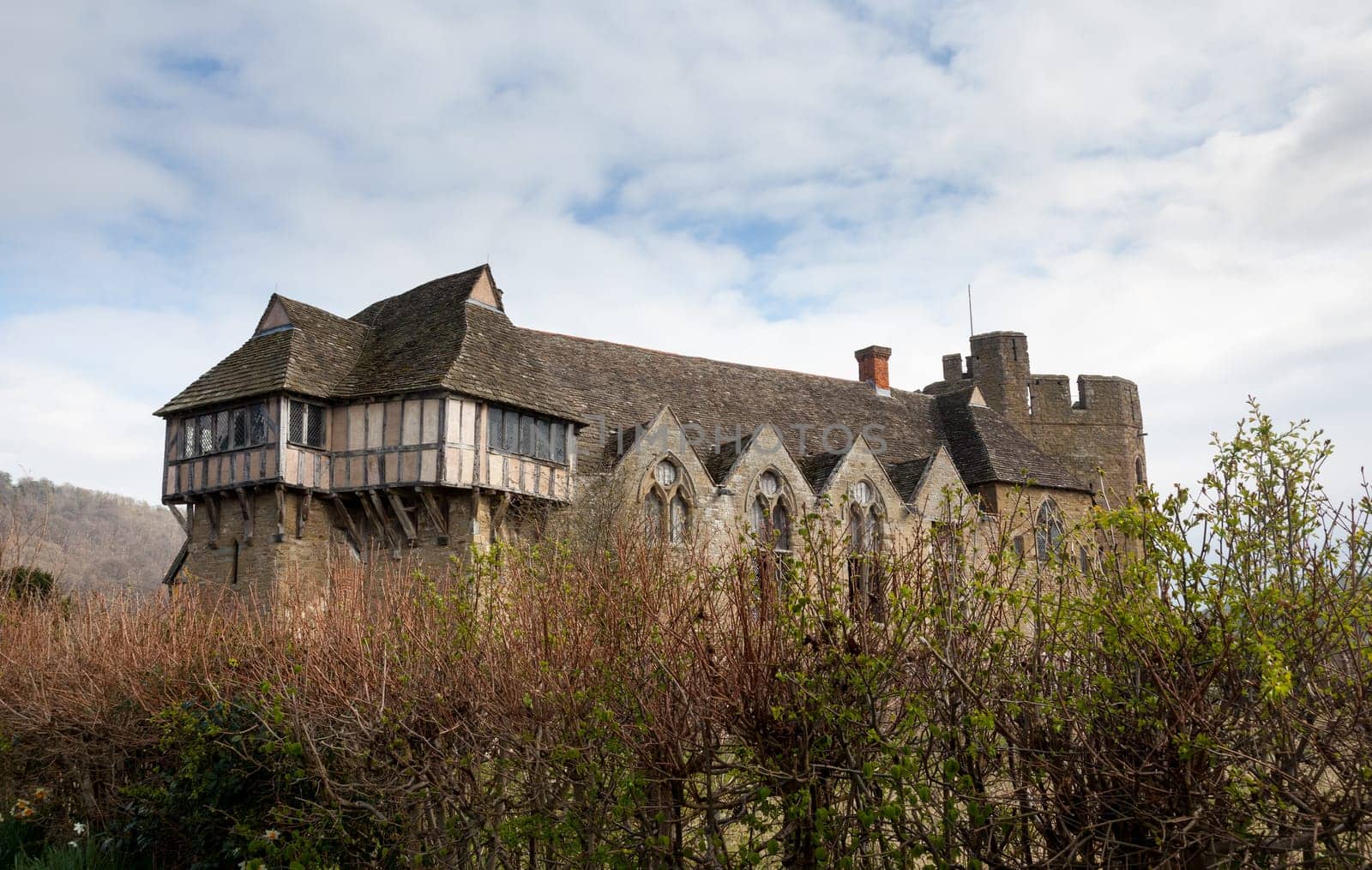 Side view of Stokesay castle in Shropshire surrounded by hedge