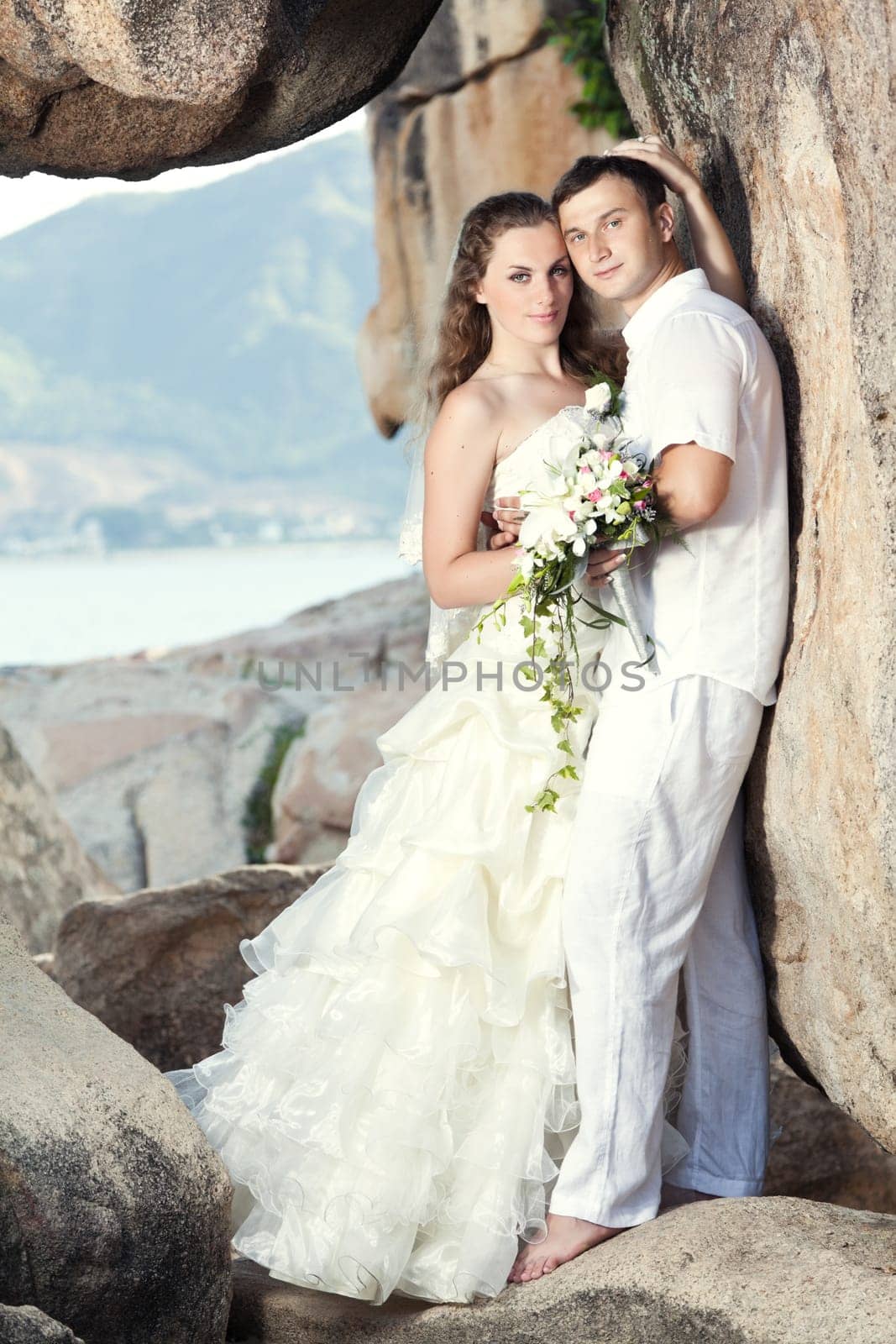 Bride and groom on the beach. Tropical wedding