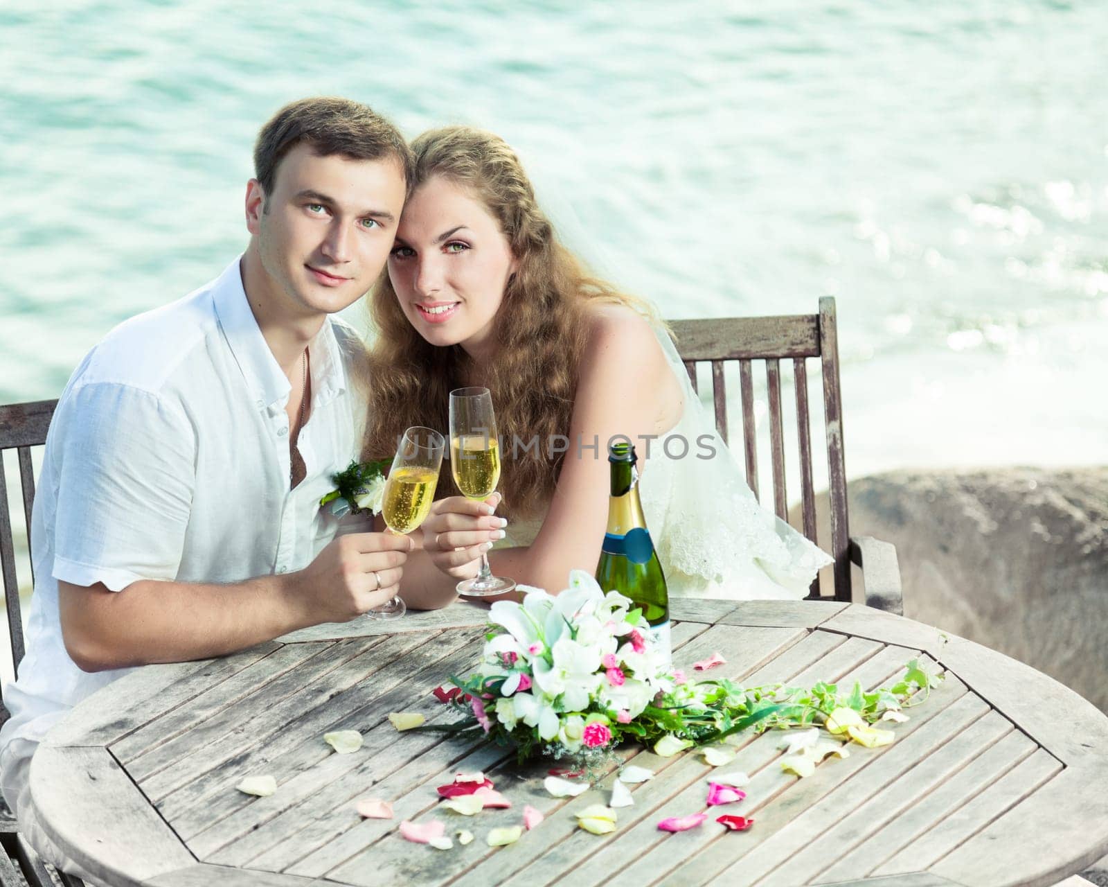 Bride and groom at wedding table near the sea