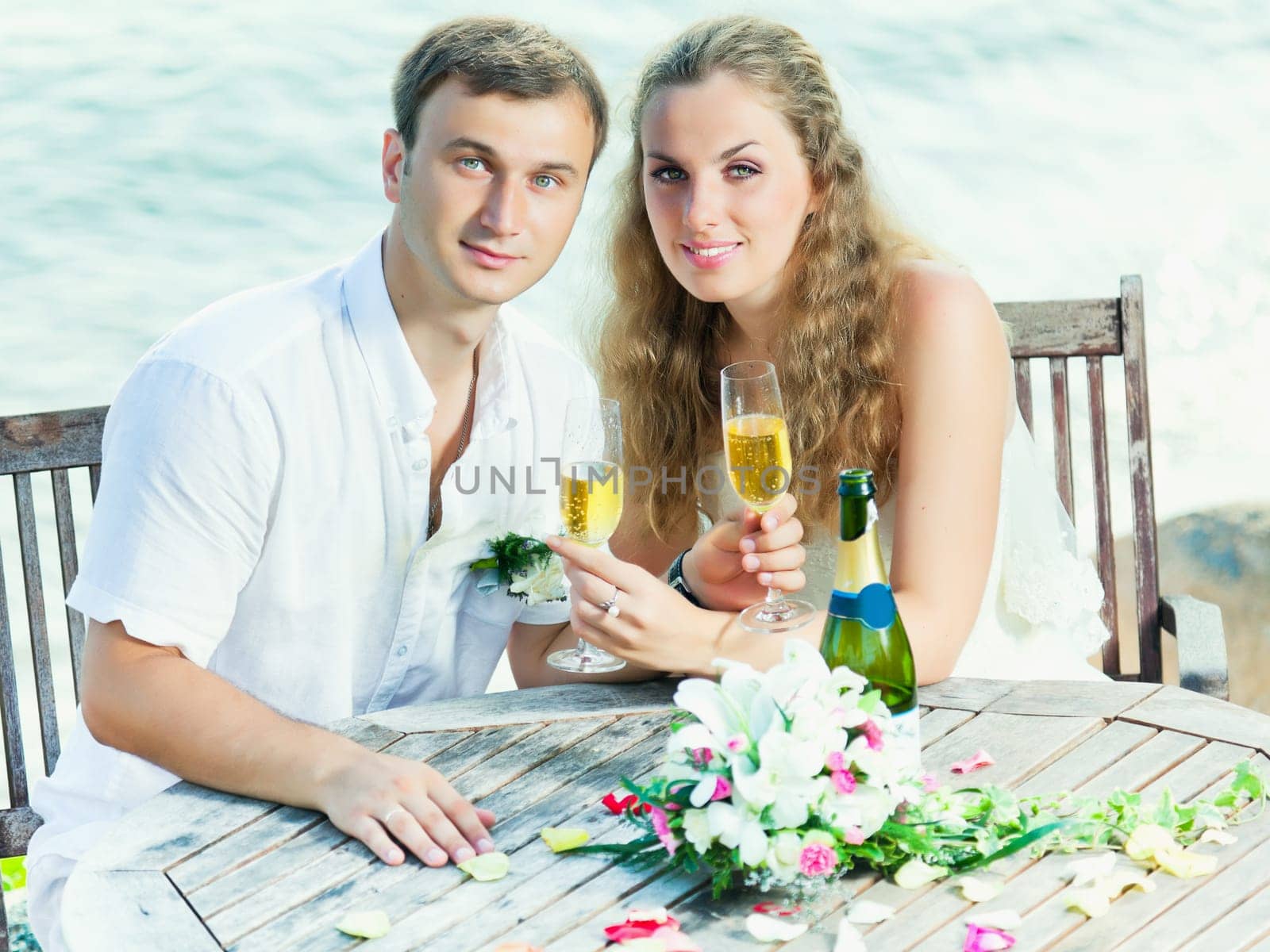 Bride and groom at wedding table near the sea