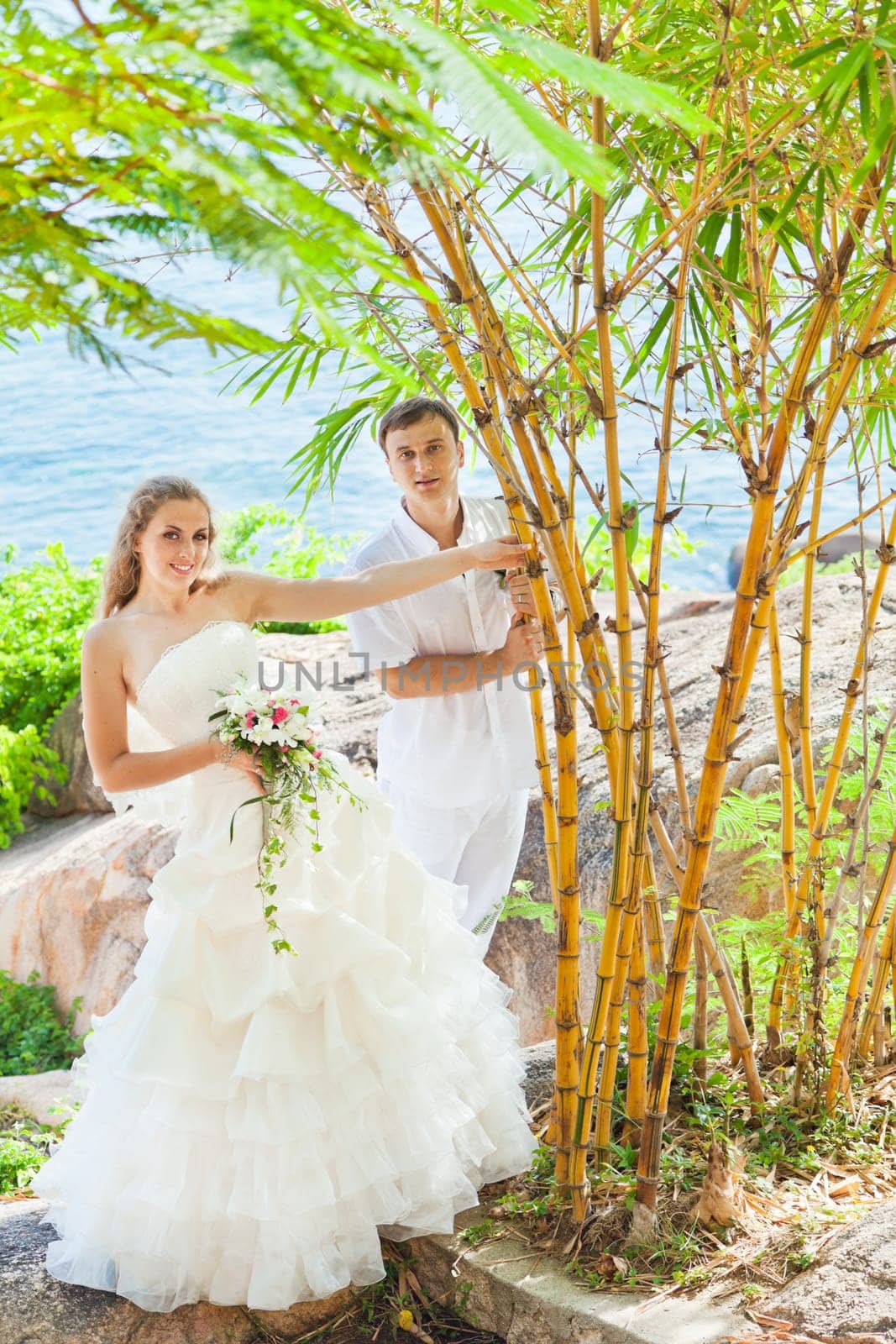 Bride and groom on the beach. Tropical wedding