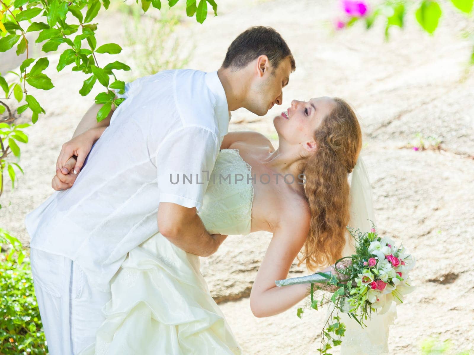 Bride and groom in a tropical garden