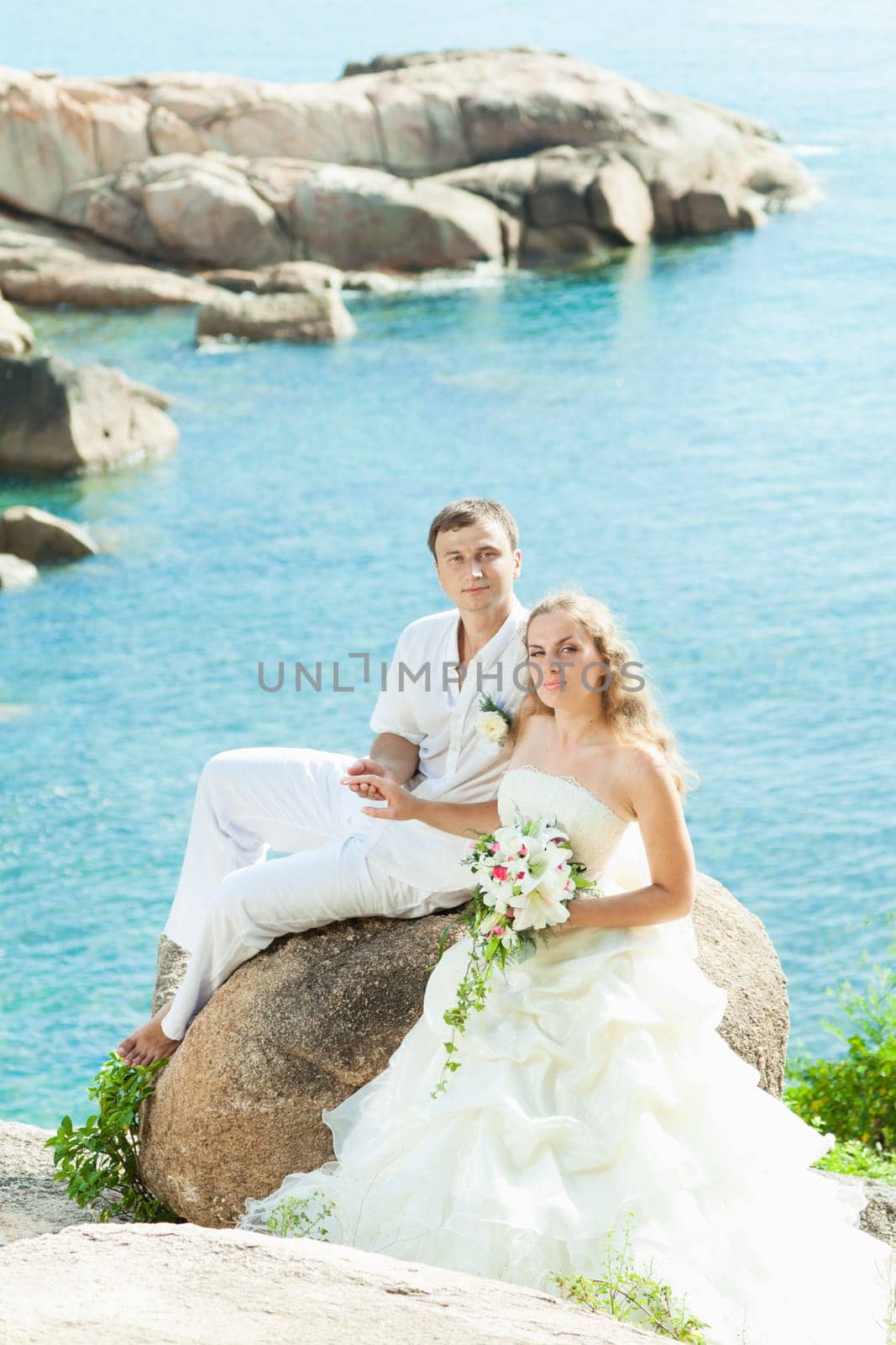 Bride and groom on the beach. Tropical wedding
