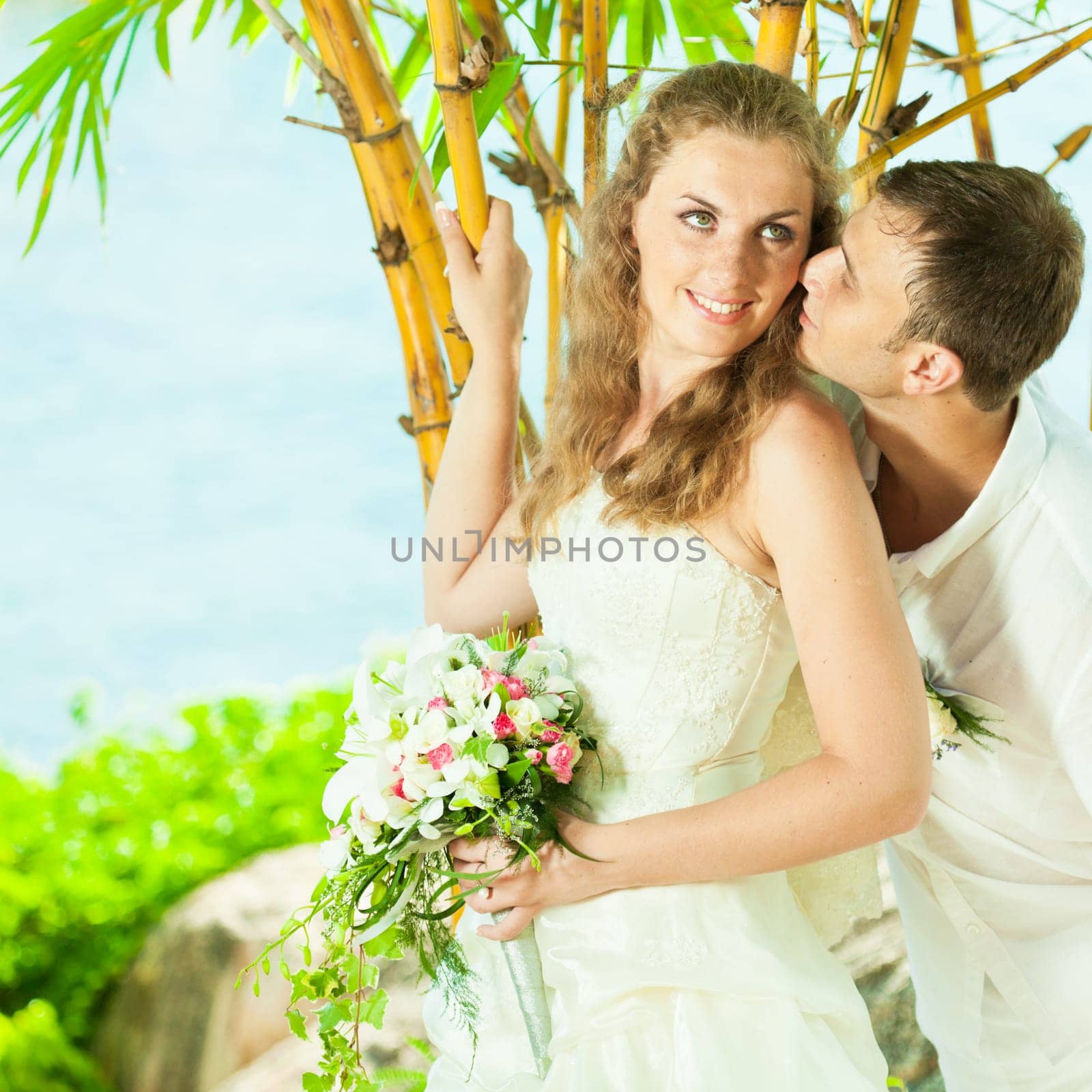 Bride and groom on the beach. Tropical wedding
