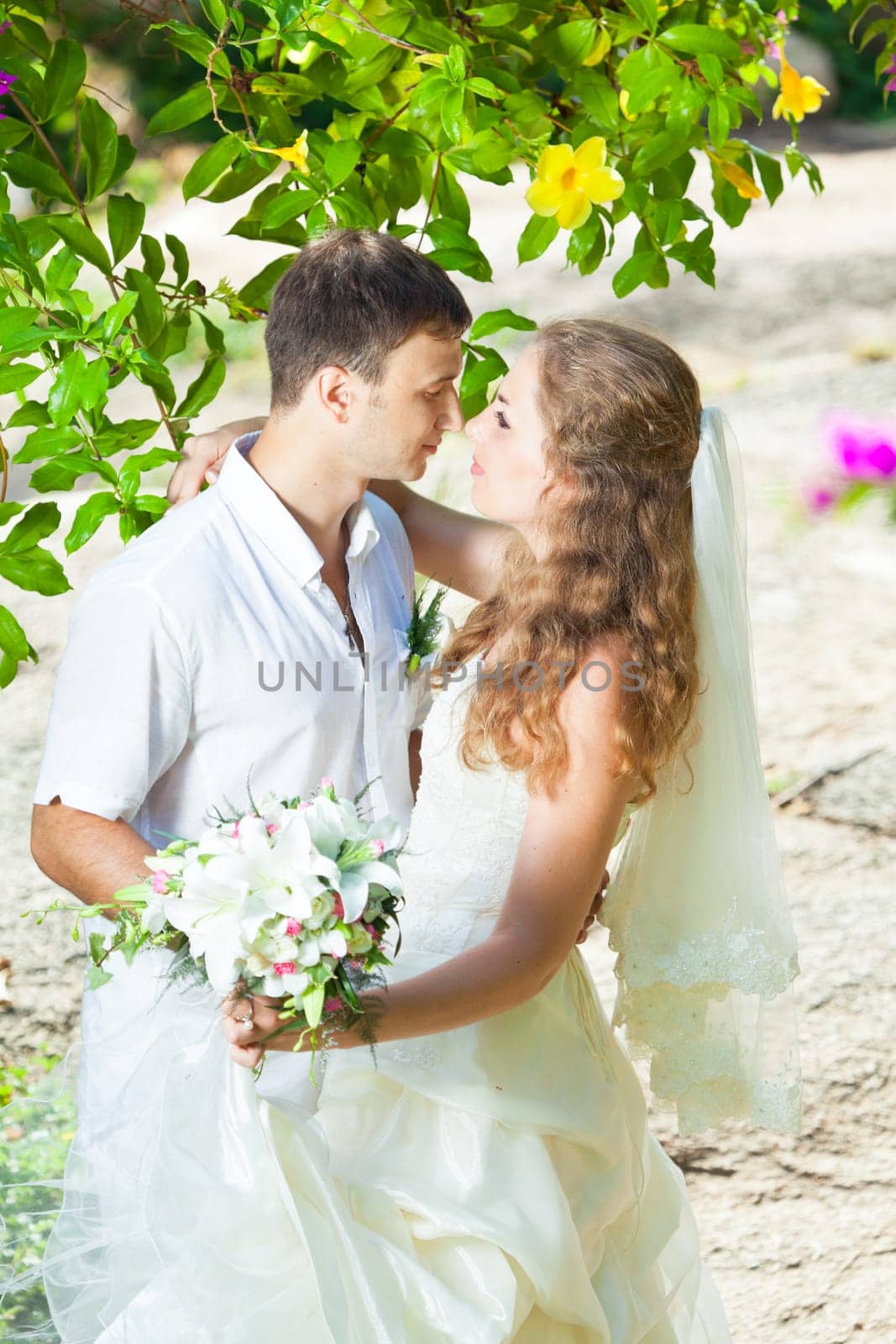 Bride and groom in a tropical garden