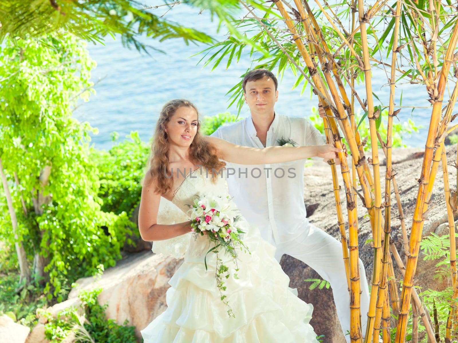 Bride and groom on the beach. Tropical wedding