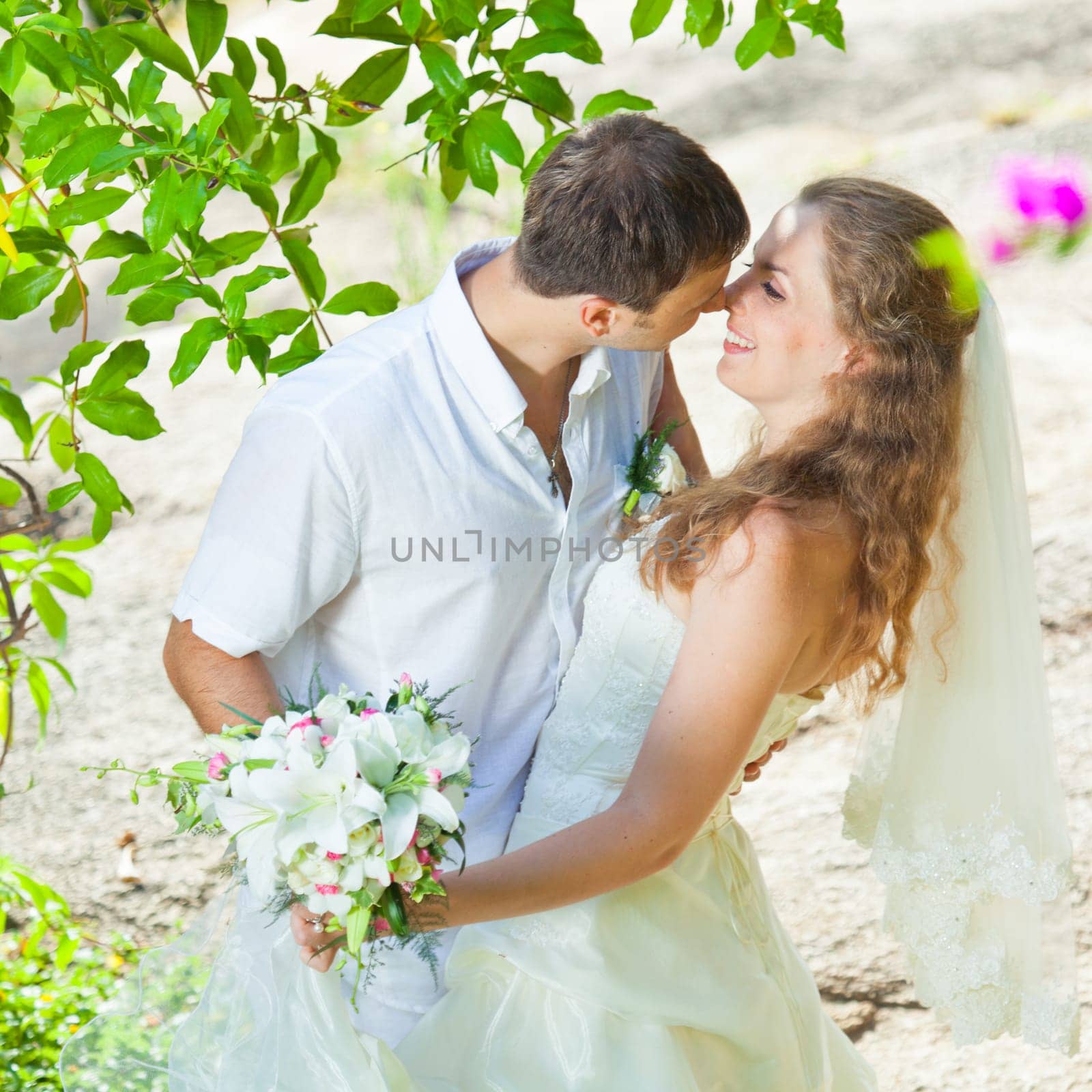 Bride and groom in a tropical garden