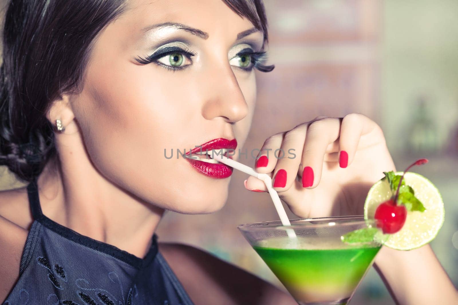 Fashion woman retro portrait with a cocktail